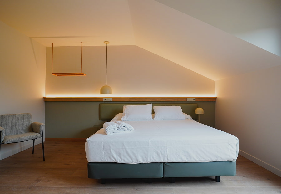 Superior double room with king size bed and lamps Superior double room with king size bed, chair and designer lamps