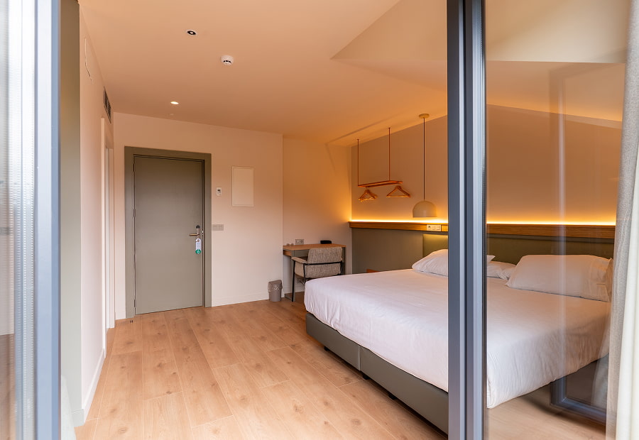 Superior double room with balcony view Modern superior double room with king-size bed, desk and designer lamps