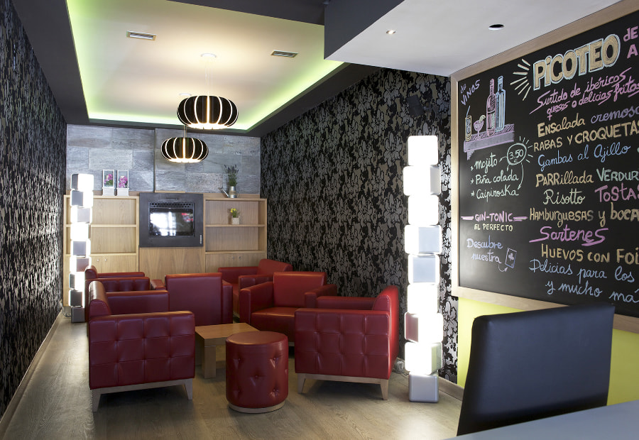 Restaurante Los Pasiegos Photograph of an area of the restaurant with the menu painted on the wall.