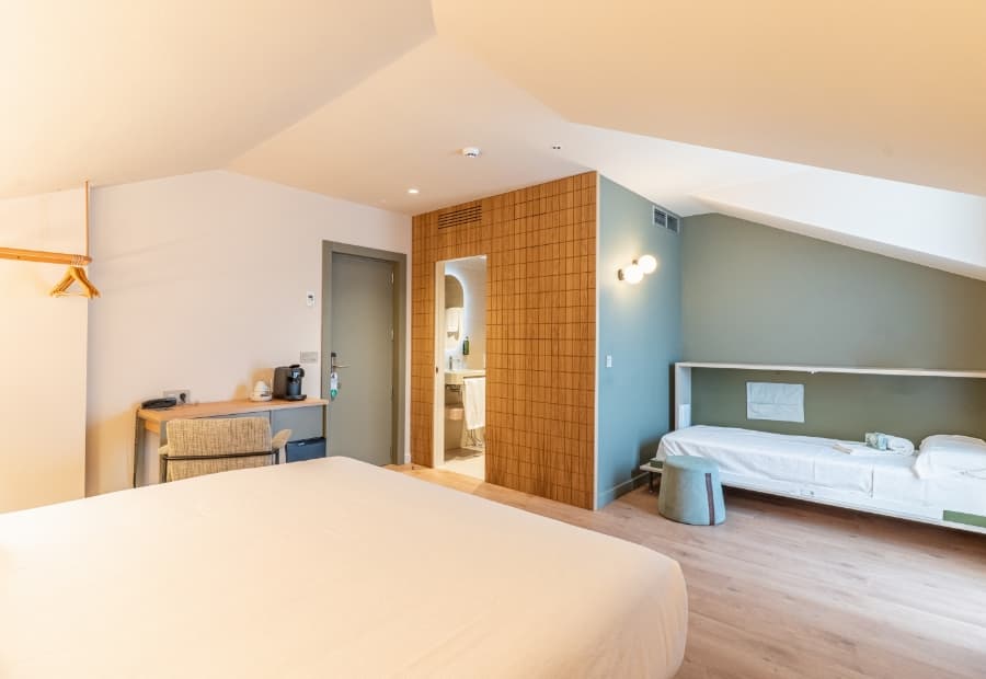 Superior triple room, general view 2 Superior triple room with extra bed, desk and amenities