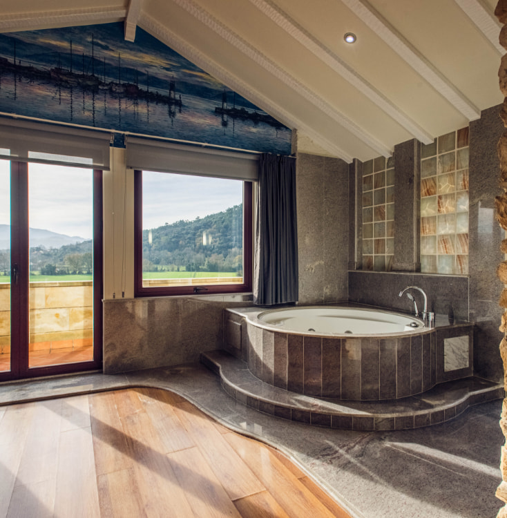 hotel spa villa pasiega Bathroom with hydro-massage bathtub and panoramic view of the outdoors